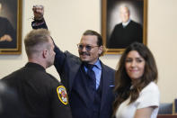 Actor Johnny Depp gestures to spectators in court after closing arguments at the Fairfax County Circuit Courthouse in Fairfax, Va., Friday, May 27, 2022. Depp sued his ex-wife Amber Heard for libel in Fairfax County Circuit Court after she wrote an op-ed piece in The Washington Post in 2018 referring to herself as a "public figure representing domestic abuse." (AP Photo/Steve Helber, Pool)