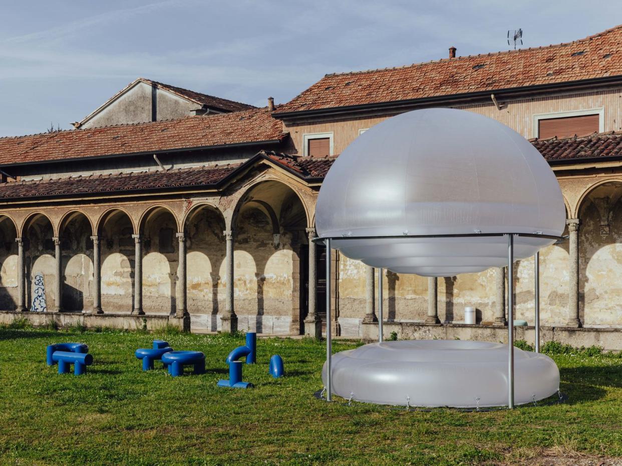 a large white dome with blue buckets in front of it