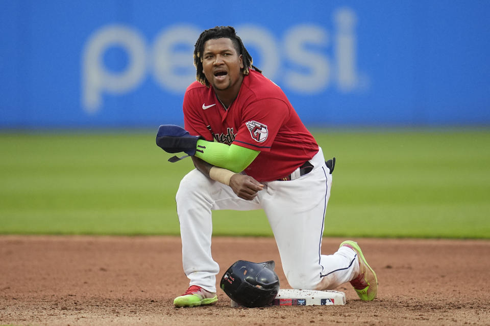 Cleveland Guardians' Jose Ramirez kneels at second base during a visit to the mound in the seventh inning of a baseball game against the Houston Astros, Saturday, June 10, 2023, in Cleveland. (AP Photo/Sue Ogrocki)