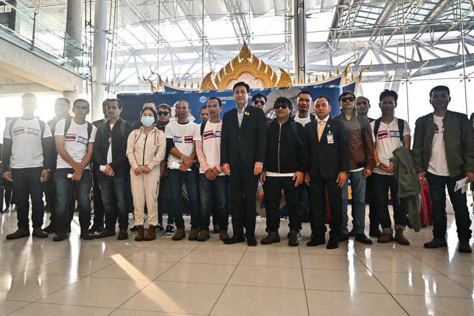 Thailand’s foreign minister Parnpree Bahiddha-Nukara (C) poses with Thai nationals, who had been kidnapped and taken hostage by Palestinian Hamas militants (AFP via Getty Images)