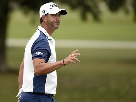 Mar 3, 2016; Miami, FL, USA; Scott Piercy waves to the gallery after putting out on the 17th green during the first round of the Cadillac Championship at TPC Blue Monster at Trump National Doral. Mandatory Credit: John David Mercer-USA TODAY Sports -