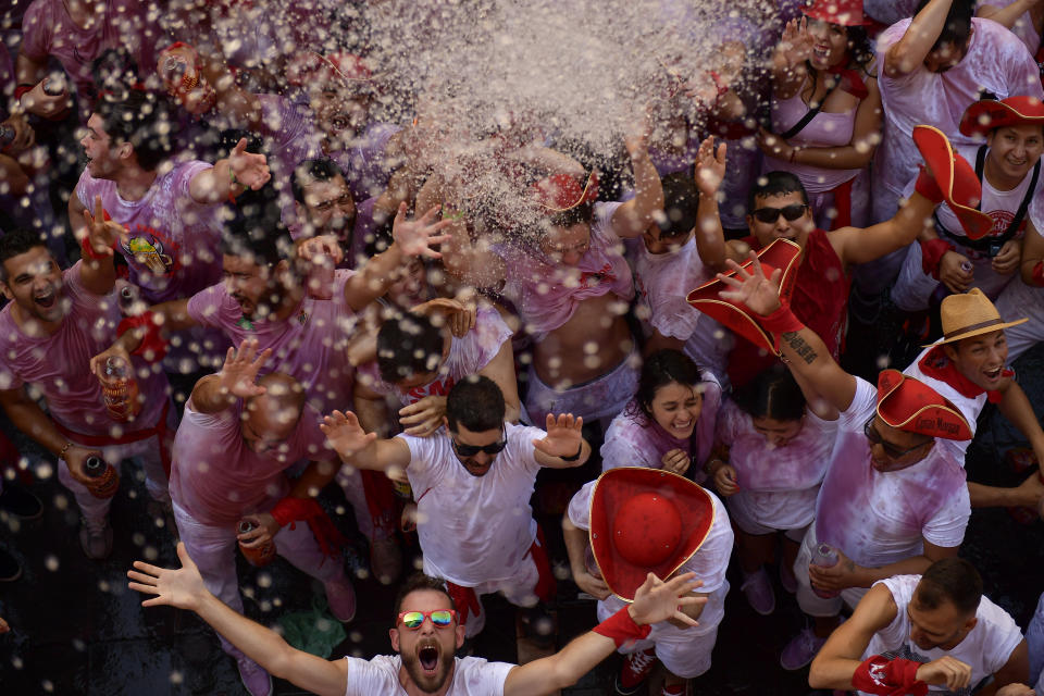 Revellers celebrate while waiting for the launch of the 'Chupinazo' rocket, to celebrate the official opening of the 2019 San Fermin fiestas with daily bull runs, bullfights, music and dancing in Pamplona, Spain, July 6, 2019. (Photo: Alvaro Barrientos/AP)