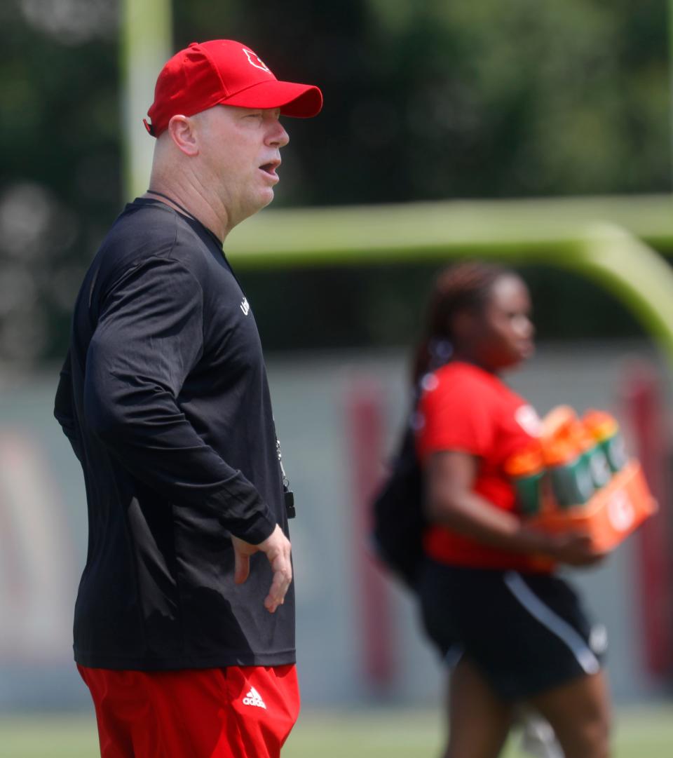 Louisville's Jeff Brohm coaches during a practice on Aug. 1, 2023.