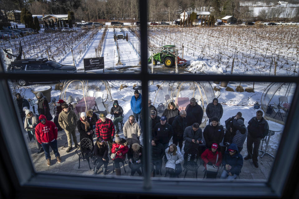 An overflow crowd waits outside before Donald Trump Jr. arrives to speak at a campaign stop for his father, Republican presidential candidate former President Donald Trump, Monday, Jan. 22, 2024, at Fulchino Vineyard in Hollis, N.H., ahead of Tuesday's New Hampshire Republican presidential primary. (AP Photo/David Goldman)