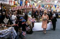 <p>Bright bunting and waving flags welcome Queen Elizabeth II to Guernsey for a state visit. (PA Archive) </p>
