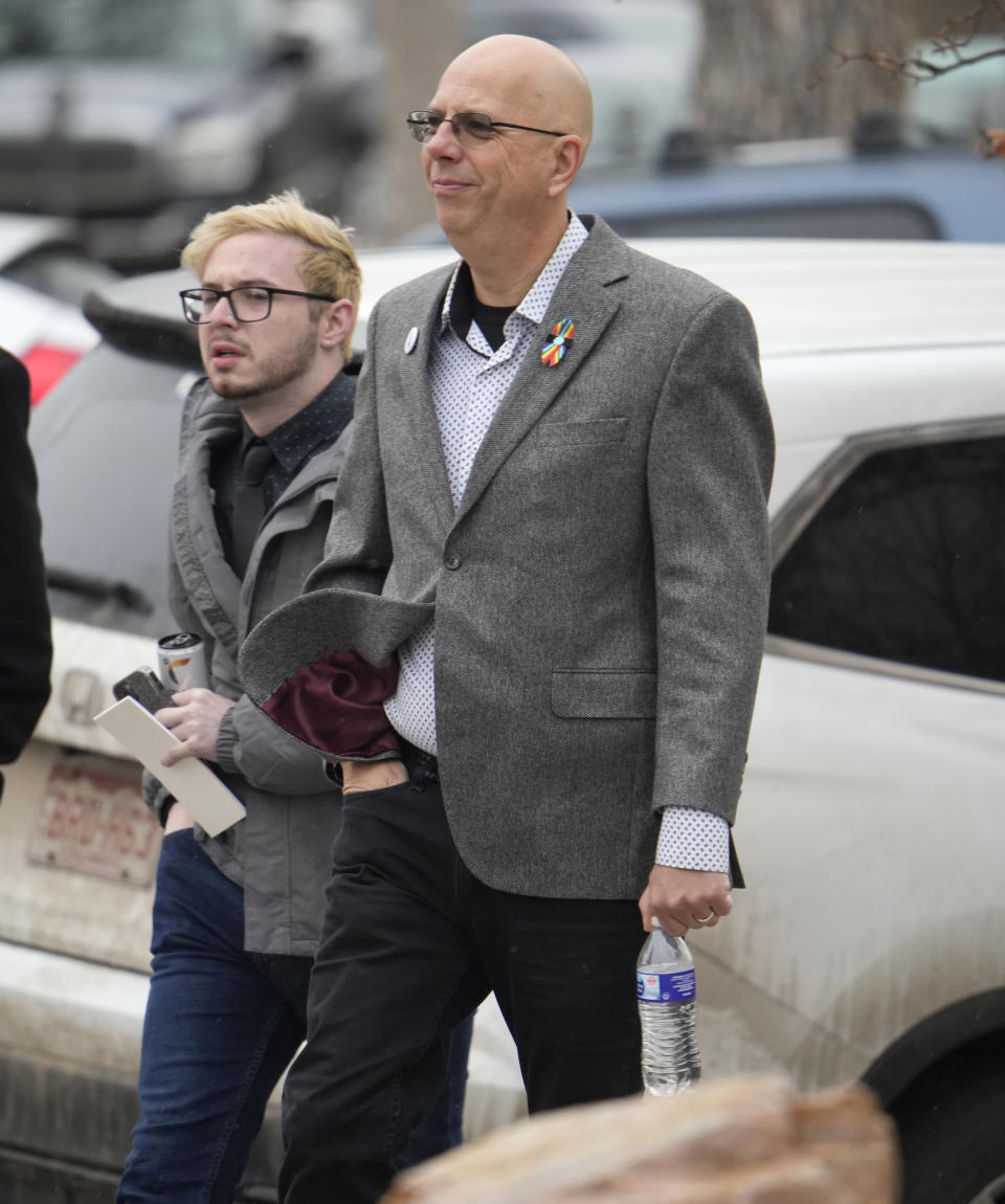 Michael Anderson, a survivor of the mass shooting at Club Q, back, walks with the club's co-owner, Matthew Haynes, into the El Paso County courthouse for a preliminary hearing for Anderson Lee Aldrich, the alleged shooter in the Club Q mass shooting Wednesday, Feb. 22, 2023, in Colorado Springs, Colo. (AP Photo/David Zalubowski)