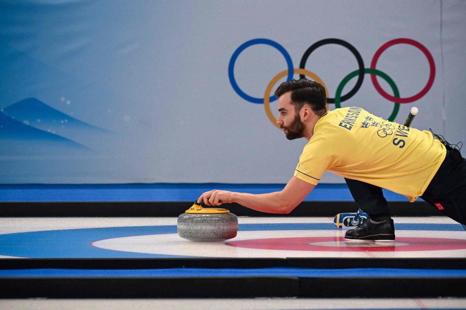 Sweden’s Oskar Eriksson curls the stone during the mixed doubles round robin session 7 game of the Beijing 2022 Winter Olympic Games curling competition between Switzerland and Sweden (Getty Images)