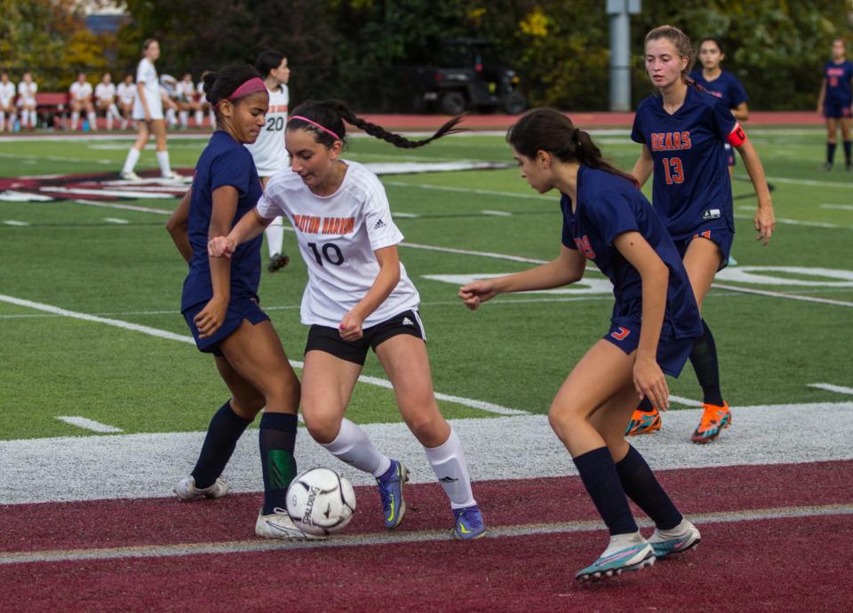 Croton-Harmon's Juliet Skrelja (10) dribbles through a couple of Briarcliff defenders during the Section 1 Class B finals at Nyack High School on Oct. 28, 2023.