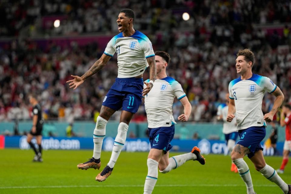 England's Marcus Rashford celebrates after scoring (Associated Press)