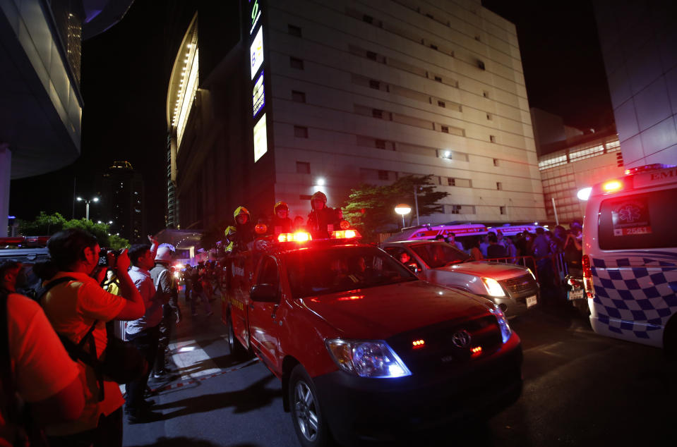 Firefighters work at the scene of a fire outside a mall complex, Wednesday, April 10, 2019, in downtown Bangkok, Thailand. The fire had broken out in the Central World mall complex in Thailand's capital, with reports from emergency services saying it has caused a number of fatalities. (AP Photo/Sakchai Lalit)