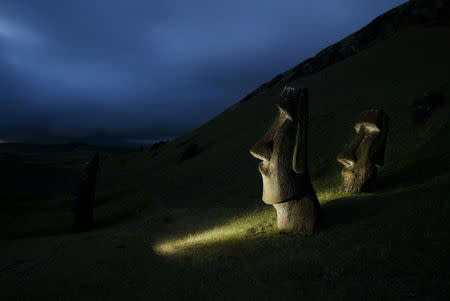 FILE PHOTO: A view of "Moai" statues in Rano Raraku volcano, on Easter Island, 4,000 km (2,486 miles) west of Santiago, Oct. 31, 2003. REUTERS/Carlos Barria/File Photo