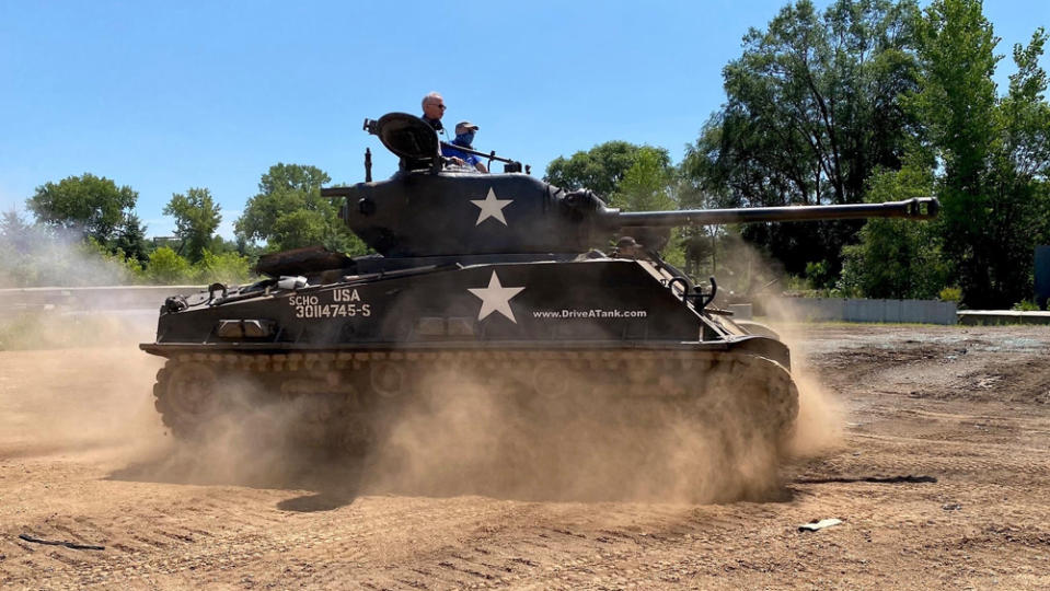 Customers operate an M4 Sherman E8 tank at Drive a Tank in Kasota, Minn.