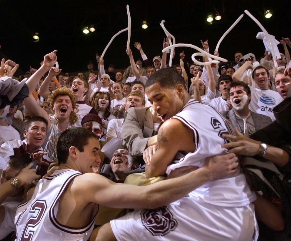 Missouri State players Shane Laurie, left, and Dale Lamberth jump into the student section to celebrate their win over Creighton Saturday night.