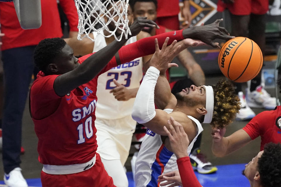 SMU forward Yor Anei (10) blocks a shot by Boise State guard Marcus Shaver Jr. during the first half of an NCAA college basketball game in the first round of the NIT, Thursday, March 18, 2021, in Frisco, Texas. (AP Photo/Tony Gutierrez)