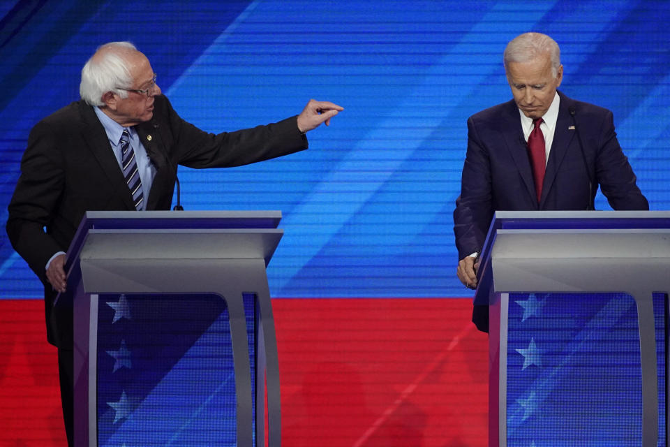 Sen. Bernie Sanders, I-Vt., left, speaks as former Vice President Joe Biden, right, listens Thursday, Sept. 12, 2019, during a Democratic presidential primary debate hosted by ABC at Texas Southern University in Houston. (AP Photo/David J. Phillip)