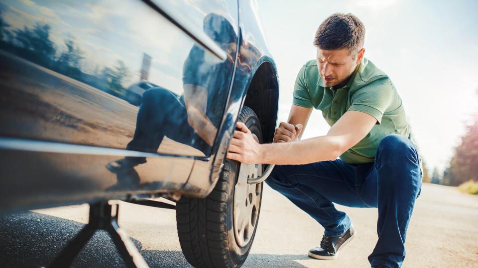 Man changing wheel after a car breakdown.