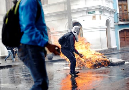 Demonstrators clash with riot police during protests after Ecuador's President Lenin Moreno's government ended four-decade-old fuel subsidies, in Quito