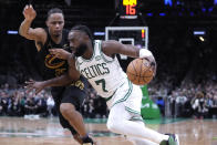 Boston Celtics guard Jaylen Brown (7) drives to the basket against Cleveland Cavaliers forward Isaac Okoro during the second half of Game 1 of an NBA basketball second-round playoff series Tuesday, May 7, 2024, in Boston. (AP Photo/Charles Krupa)