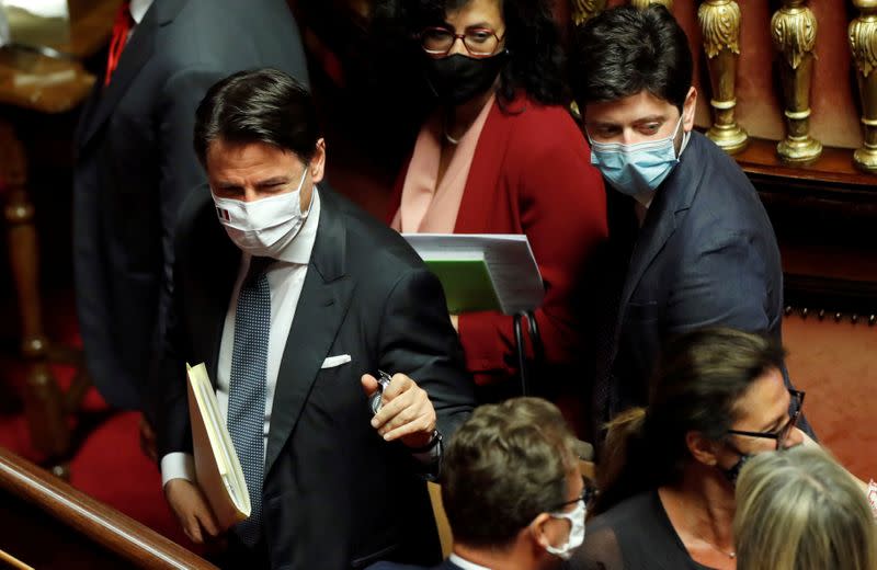 FILE PHOTO: Italian Prime Minister Giuseppe Conte and Health Minister Roberto Speranza leave after attending a session of the upper house of parliament in Rome