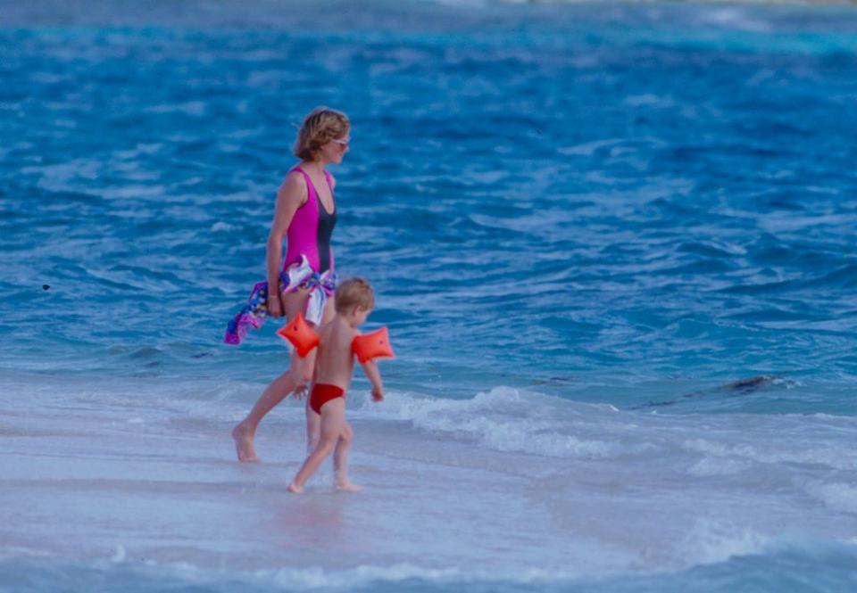 <p>Here, Diana holds little Harry's hand in the waters of Necker Island. Richard Branson's personal island was a popular vacation spot for the family, and they'd return the following year. </p>