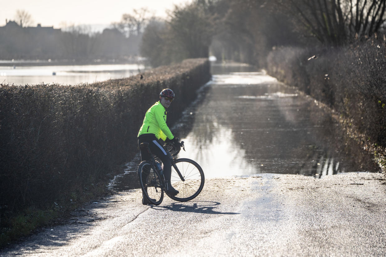 A cyclist turns around to avoid flood waters in Somerset on Monday. (PA)