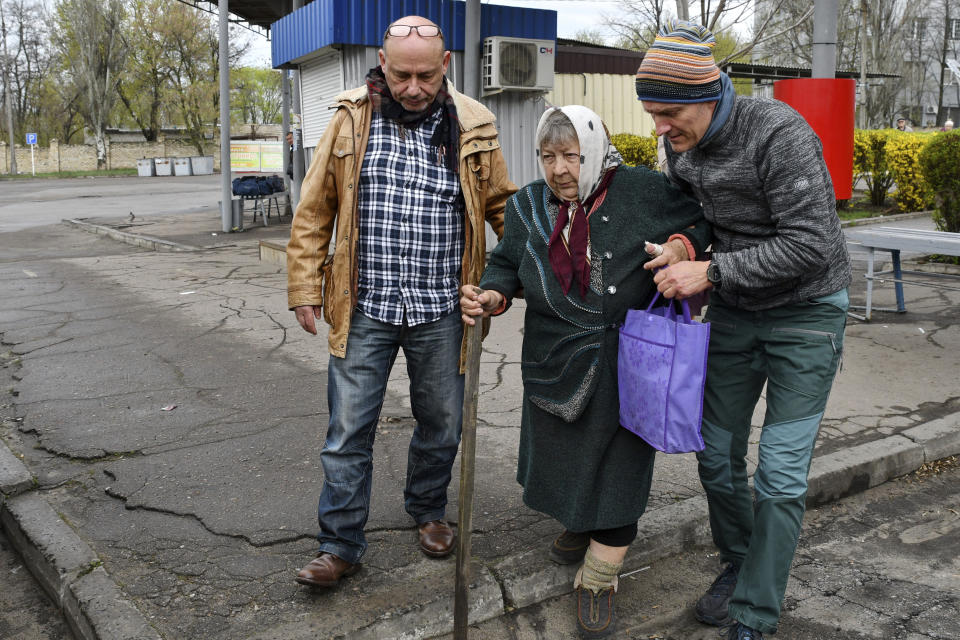 Men help Maria Dyachenko, 83, to board a transport during evacuation of civilians in Kramatorsk, Ukraine, Tuesday, April 12, 2022. Maria left the village of Dovhenke, about 25 km south of Izyum, Kharkiv region. She told her village was completely destroyed during fightings between Russian and Ukrainian forces, only few houses are intact there. Maria came to Kramatorsk to get chance for evacuation and asked volunteers to move her to Ukrainian city of Dnipro. (AP Photo/Andriy Andriyenko)