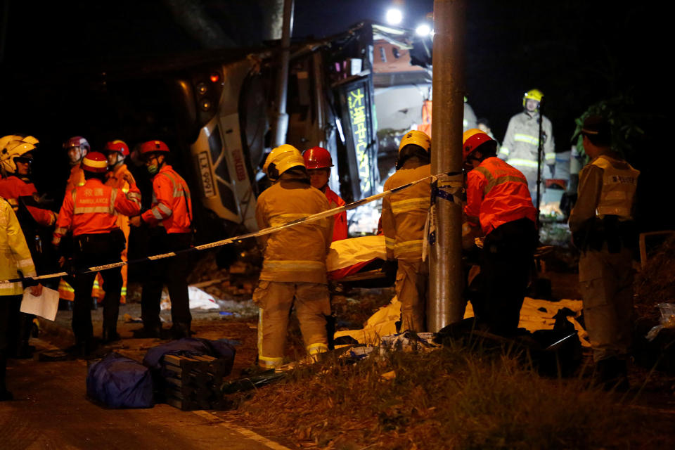 <p>Rescuers work near a crashed bus in Hong Kong, China, Feb. 10, 2018. (Photo: Bobby Yip/Reuters) </p>