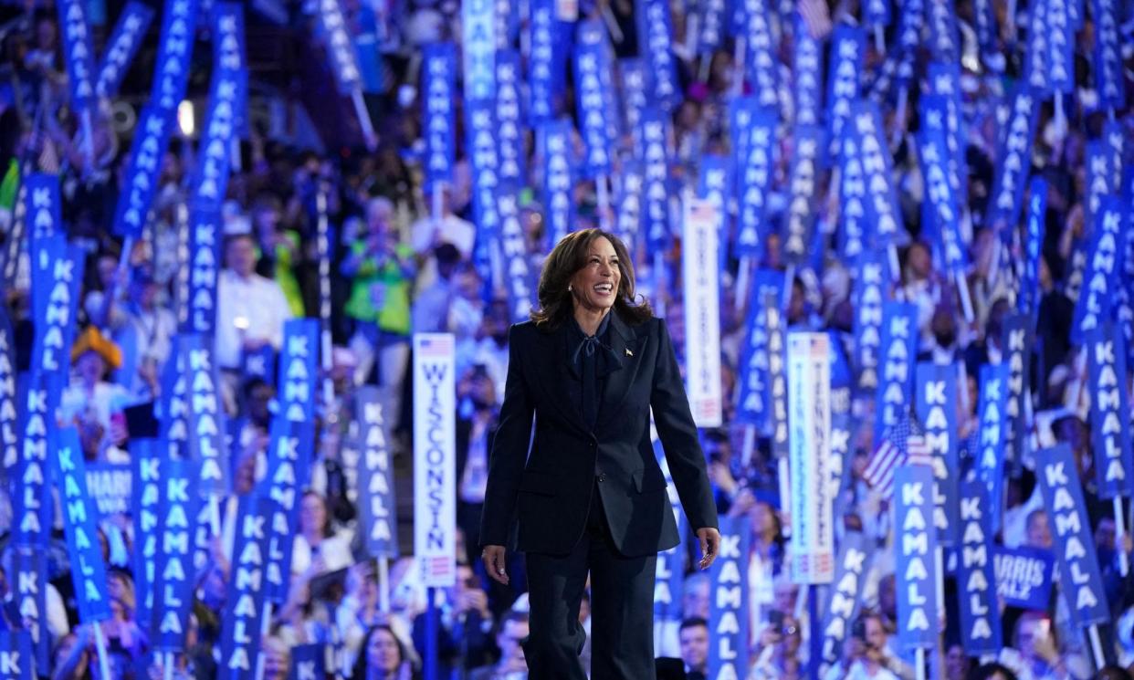 <span>Kamala Harris takes the stage to make her acceptance speech.</span><span>Photograph: Kevin Lamarque/Reuters</span>