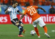 Argentina's Gonzalo Higuain fights for the ball with Georginio Wijnaldum of the Netherlands (R) during their 2014 World Cup semi-finals at the Corinthians arena in Sao Paulo July 9, 2014. REUTERS/Dominic Ebenbichler