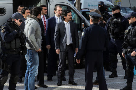 The eight Turkish soldiers, who fled to Greece in a helicopter and requested political asylum after a failed military coup against the government, are escorted by police officers as they arrive at the Supreme Court in Athens, Greece, January 23, 2017. REUTERS/Alkis Konstantinidis