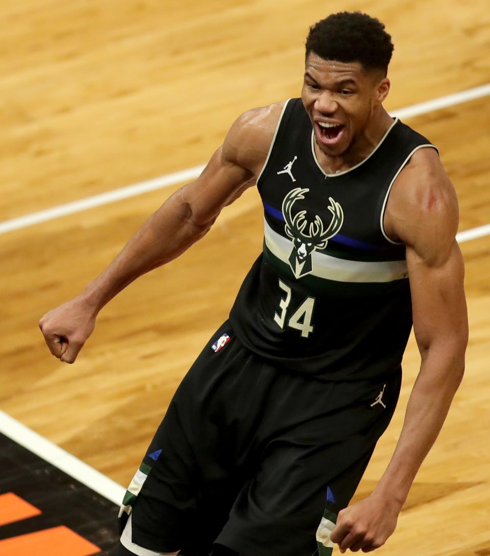 Bucks forward Giannis Antetokounmpo celebrates his after slam dunk with 10.3 seconds left in the game against the Clippers Feb. 28, 2021.