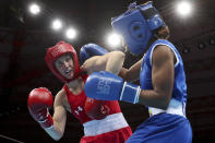 FILE - Virginia Fuchs of the United States, left, battles Ingrit Valencia of Colombia and during a women's flyweight boxing final bout at the Pan American Games in Lima, Peru, in this Friday, Aug. 2, 2019, file photo. Ginny Fuchs’ obsessive-compulsive disorder sometimes compels her to use a dozen toothbrushes a night and to buy hundreds of dollars of cleaning products per week. Yet Fuchs is headed to Tokyo next week to compete in the Olympic boxing tournament, where she realizes it’s almost impossible to avoid touching the blood, sweat and spit of her opponents. (AP Photo/Martin Mejia, File)