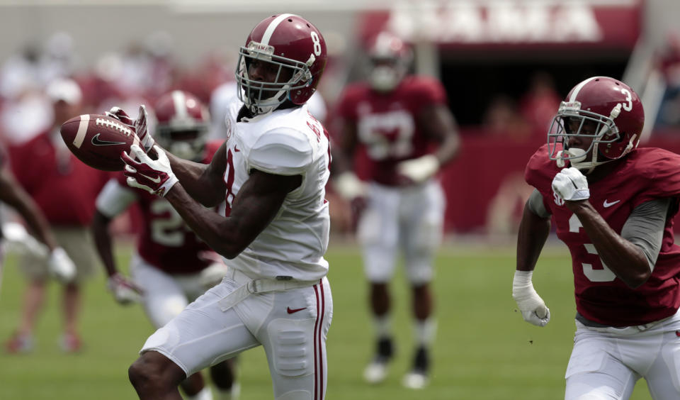 FILE - In this April 18, 2015, file photo, Alabama wide receiver Robert Foster (8) catches a pass and runs for a first down during the first half of Alabama's spring NCAA college football game in Tuscaloosa, Ala. Alabama's receiving corps doesn't have an Amari Cooper this season, just a bunch of guys who were at least as highly recruited as the Heisman Trophy finalist. (AP Photo/Butch Dill, File)