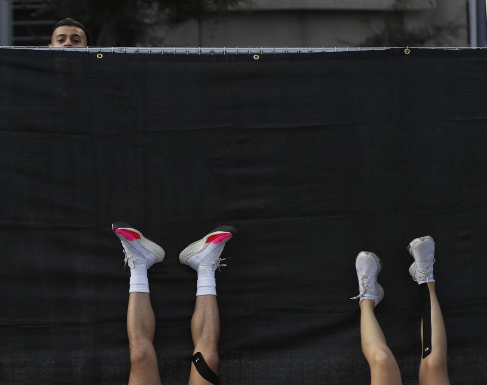 Exhausted runners rest after completing the Los Angeles Marathon.