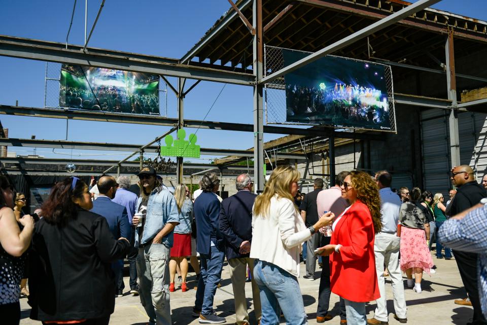 Attendees mingle in the Trueline venue during a groundbreaking event for the new music venue in the West End in Greenville, S.C., on Thursday, April 25, 2024.