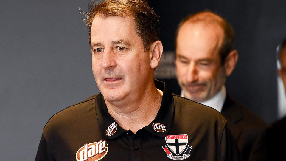 Ross Lyon is pictured entering his introductory press conference as coach of St Kilda.