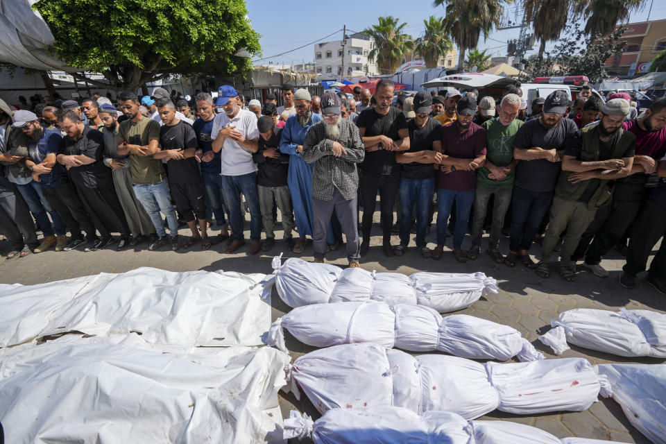 Palestinians mourn relatives killed in an Israeli strike on a U.N.-run school in the Nusseirat refugee camp, outside a hospital in Deir al Balah, Gaza Strip, Thursday, June 6, 2024. The Israeli military said that Hamas militants were operating from within the school. (AP Photo/Abdel Kareem Hana)