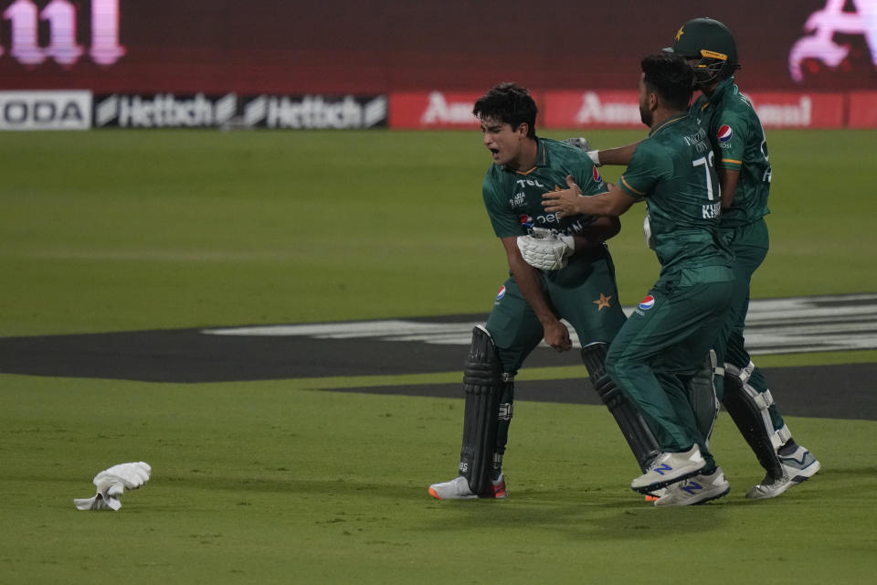 Pakistan's Naseem Shah, left, and teammates celebrate their win in the T20 cricket match of Asia Cup against Afghanistan, in Sharjah, United Arab Emirates, Wednesday, Sept. 7, 2022. (AP Photo/Anjum Naveed)