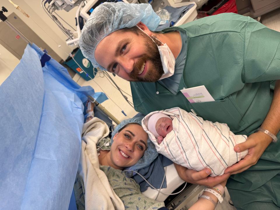 New mom Jackie Kunzelman and her husband, Nic, with their baby boy, Rocky, in the operating room.