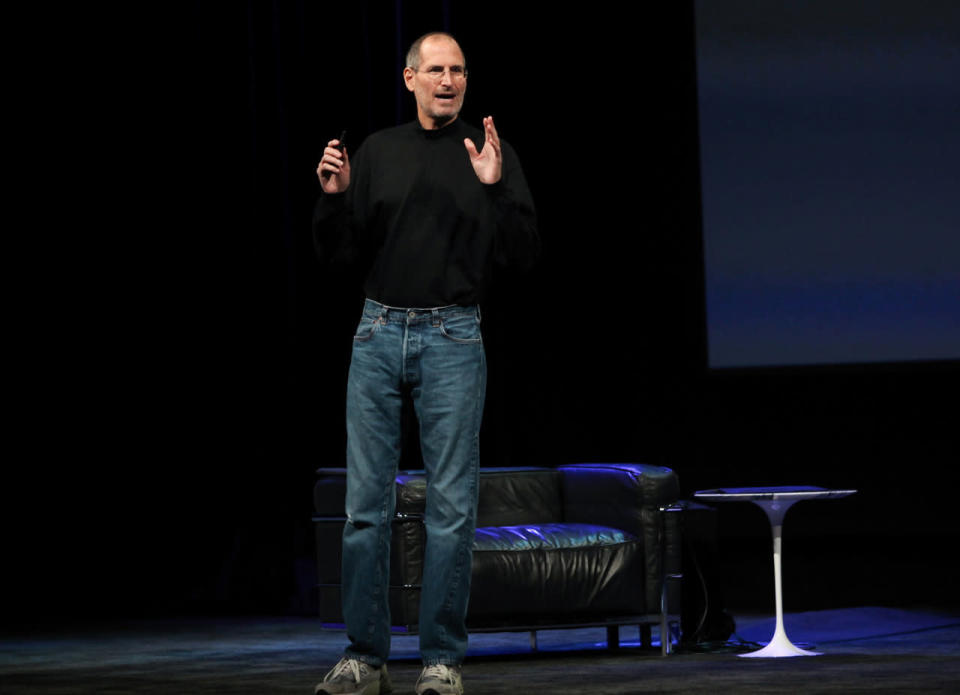 Steve Jobs wears his classic uniform: 501s and a black turtleneck