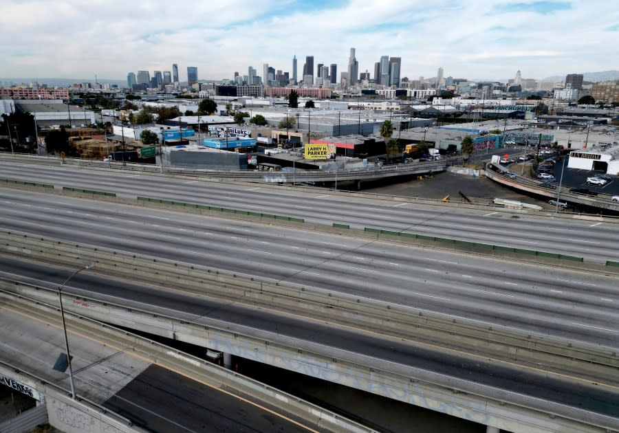 A portion of Interstate 10 freeway in Los Angeles between Alameda Street and Santa Fe Avenue in empty, on Monday, Nov. 13, 2023. A large fire broke out under the 10 freeway Saturday after midnight, fully engulfing multiple pallets, vehicles, and trailers and causing extensive damage to the freeway. (Dean Musgrove/The Orange County Register via AP)