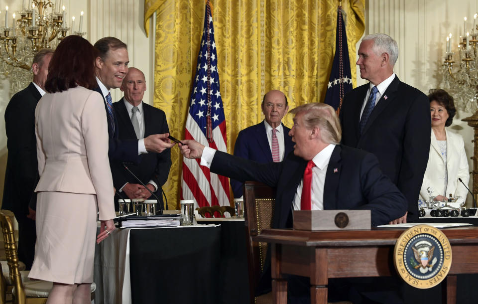 President Trump hands a pen to Jim Bridenstine, third from left, after signing a space policy directive, June 18, 2018. (Photo: Susan Walsh/AP)