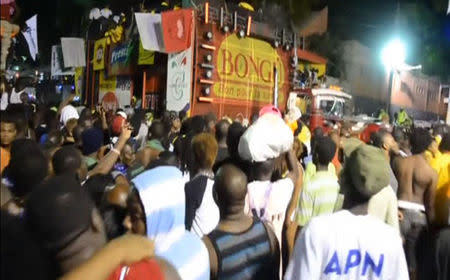 People gather after a carnival float hit power lines, on the second day of the annual Carnival celebrations in Haiti's capital Port-au-Prince in this February 17, 2015 still image taken from Reuters TV. REUTERS/Reuters TV