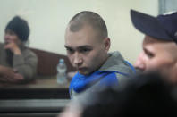 Russian army Sergeant Vadim Shishimarin, 21, is seen behind a glass during a court hearing in Kyiv, Ukraine, Wednesday, May 18, 2022. The Russian soldier has gone on trial in Ukraine for the killing of an unarmed civilian. The case that opened in Kyiv marked the first time a member of the Russian military has been prosecuted for a war crime since Russia invaded Ukraine 11 weeks ago. (AP Photo/Efrem Lukatsky)