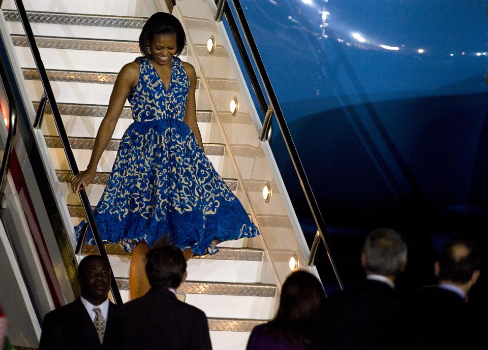 Michelle Obama arrives in Mexico City wearing a blue dress.