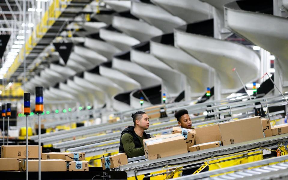 Retail warehouses tend to be vast buildings of conveyor belts and stacks of products and packaging materials. <a href="https://www.gettyimages.com/detail/news-photo/trucks-drive-by-the-scene-where-a-cargo-plane-was-searched-news-photo/106351058" rel="nofollow noopener" target="_blank" data-ylk="slk:Johannes Eisele/AFP via Getty Images;elm:context_link;itc:0;sec:content-canvas" class="link ">Johannes Eisele/AFP via Getty Images</a>