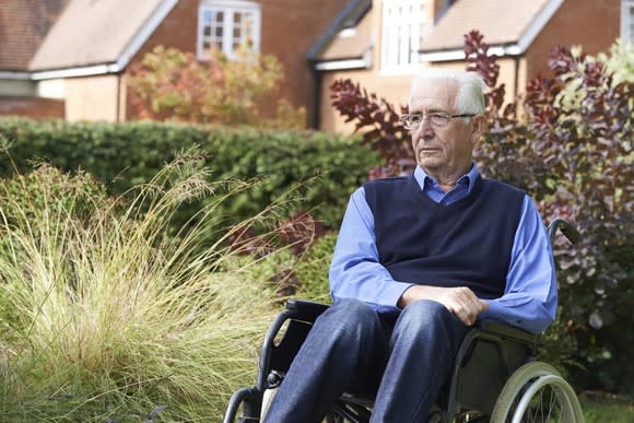 Senior man in a wheelchair outdoors