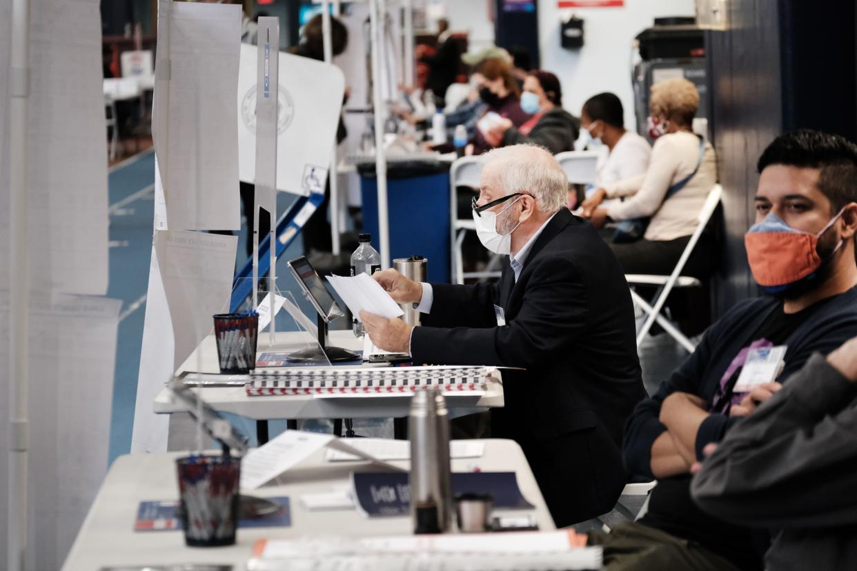 Poll workers assist voters at a voting site at a YMCA in Brooklyn on Nov. 02, 2021, on Election Day in New York City. Over 30,000 New Yorkers have already cast their ballots in early voting in New York for a series of races including for the election of the next mayor of the city.