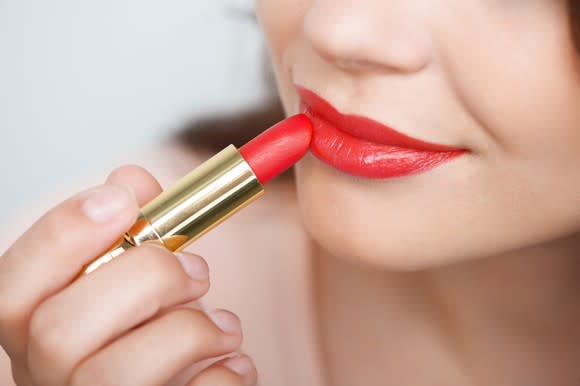 Woman applying lipstick