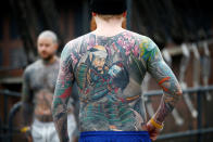 <p>Visitors to the London Tattoo Convention show off their body tattoos, in London, Britain, Sept. 23, 2017. (Photo: Peter Nicholls/Reuters) </p>